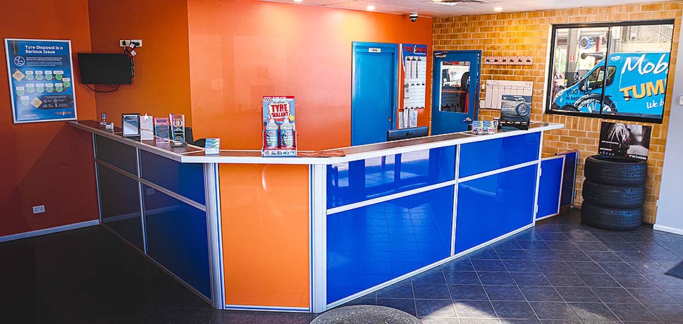 Interior of a modern reception area with orange and blue color scheme.